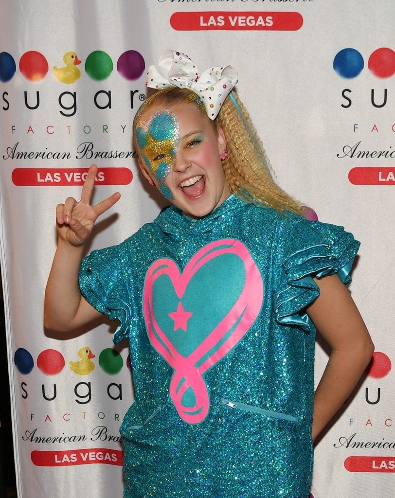 JoJo Siwa poses for pictures on the red carpet.