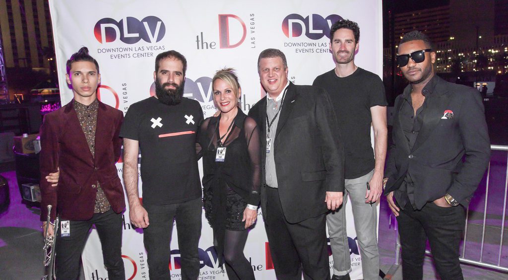 Capital Cities band members, including Sebu Simonian and Ryan Merchant pose with DLV owner Derek Stevens and Nicole Parthum before taking the stage