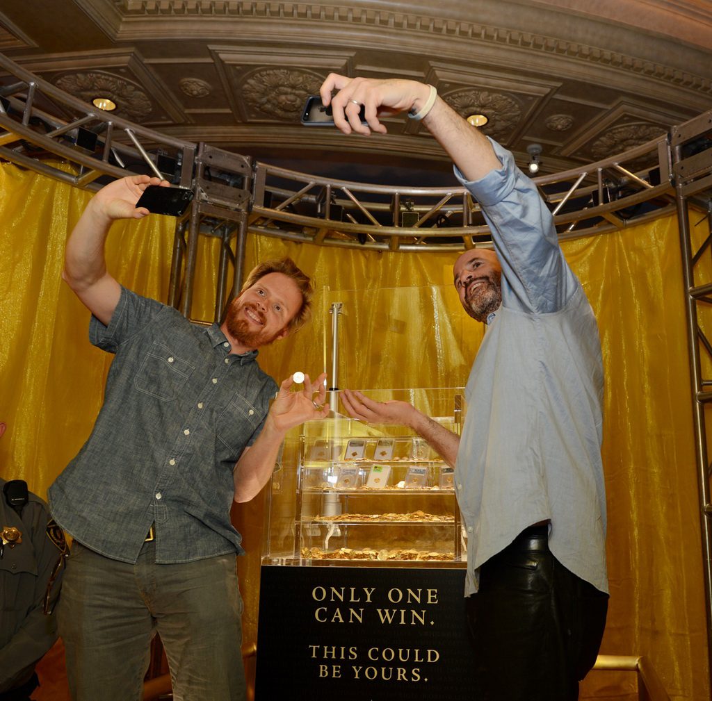 ENDGAME: The Calling co-Authors James Frey and Nils Johnson-Shelton enjoy posing with the $500,000 grand prize being displayed at Caesars Palace.