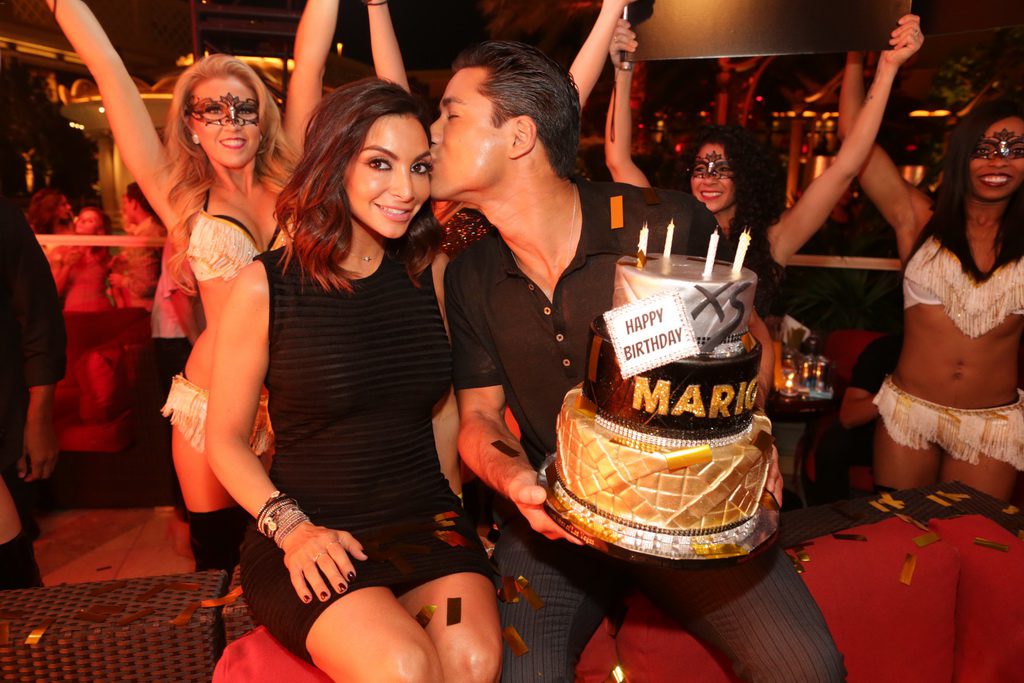 Mario Lopez gives his wife a kiss on the cheek at XS Nightclub