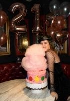 Bella Thorne takes a bite out of Sugar Factory's larger-than-life, red velvet cotton candy cake covered in pink icing