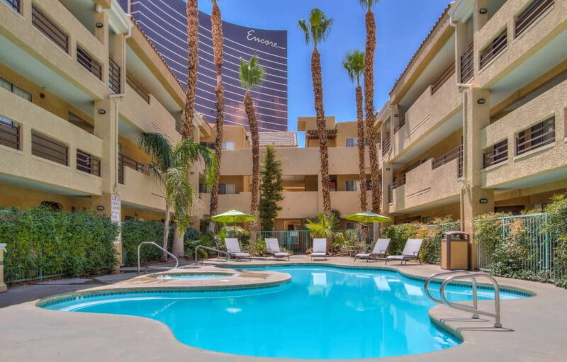 The seasonal outdoor pool and hot tub area at The Rita Suites.