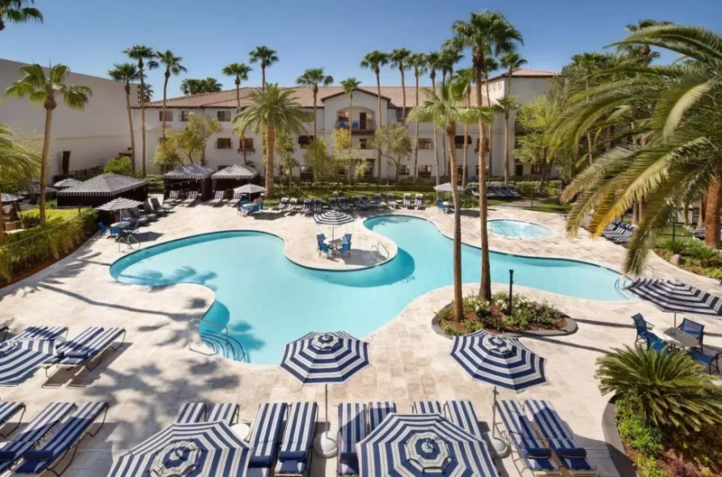 The lush, lagoon-style outdoor pool area at Tuscany Suites & Casino.