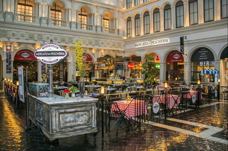 The lively outdoor patio of Mercato Della Pescheria overlooking the canals of St. Mark's Square.