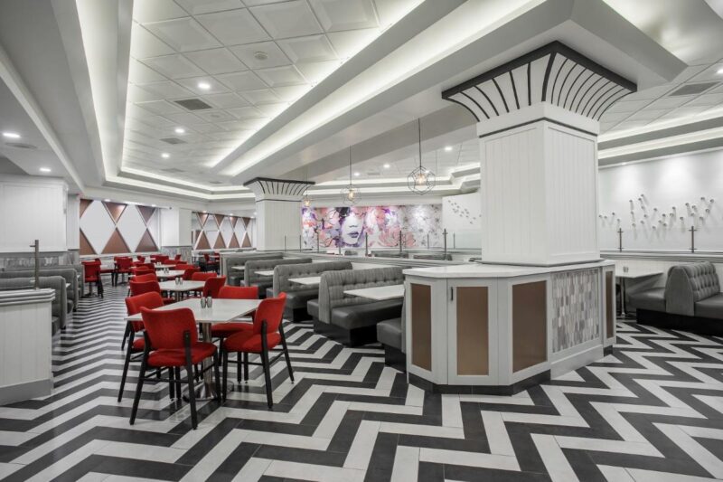 The bright and modern dining room of STRAT Cafe, featuring colorful decor and local art.