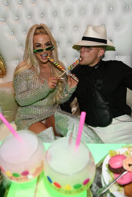 Tana Mongeau and Jake Paul sucking on Lollipops at Sugar Factory.