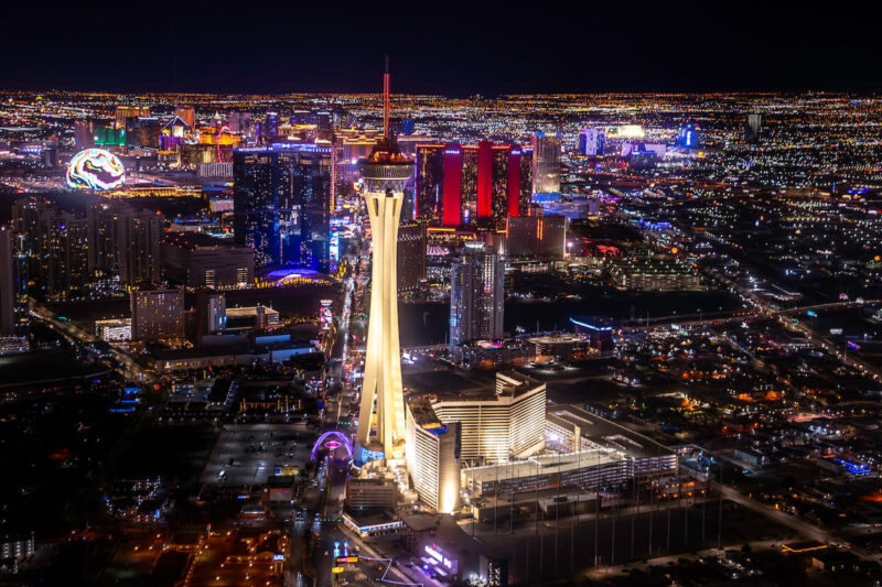 The STRAT Hotel tower soaring above the Las Vegas Strip at night.
