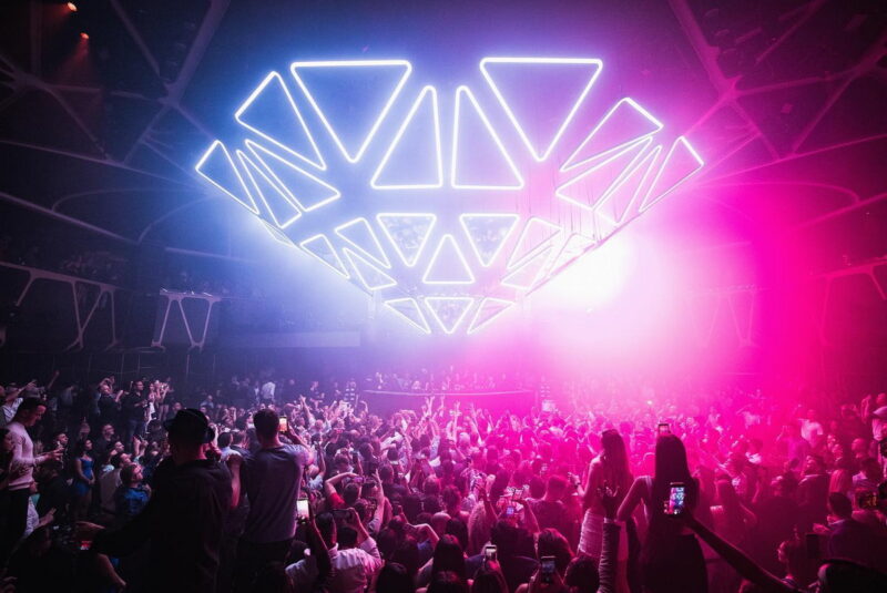 A world-class DJ performing to a packed crowd inside the main room of Hakkasan Las Vegas.