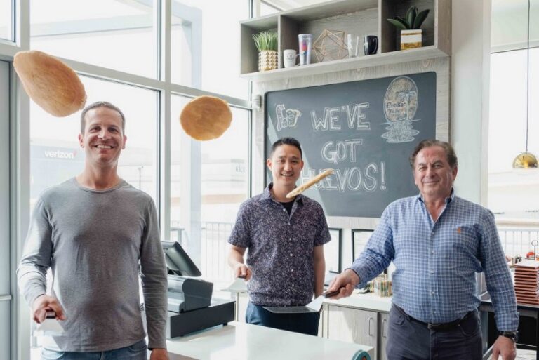 1241 Right to left Randy Corrigan Barry Tu and John Gelastopoulos officially open the restaurant with oversized pancake flip. 768x513