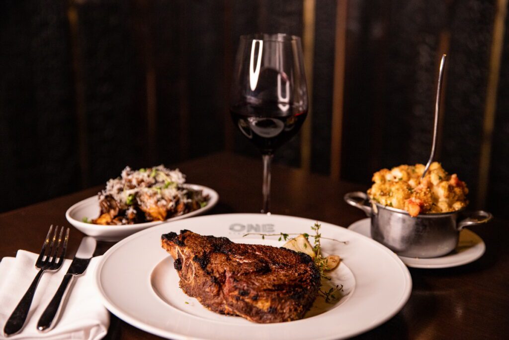24-ounce Cowboy Cut Bone-in Ribeye with Red Wine and Sides at One Steakhouse