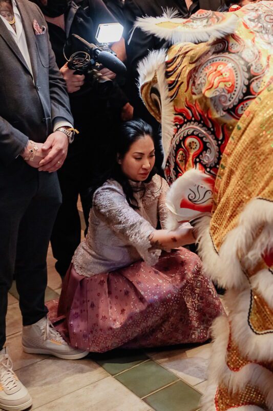 Penny Chutima feeds lion during traditional dance